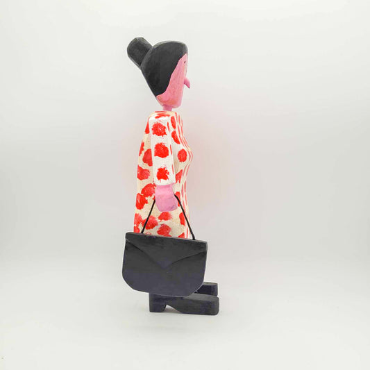 Dame en blanc et rouge, sacoche à la main droite