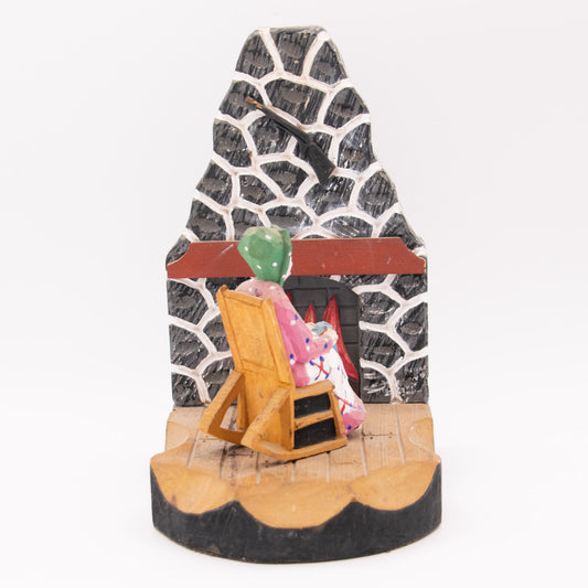 Chaise berçante devant  le feu